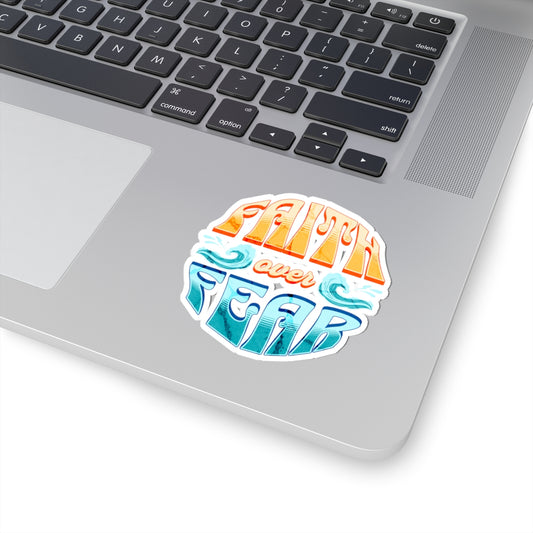 Laptop with a colorful 'Faith Over Fear' sticker on the palm rest area