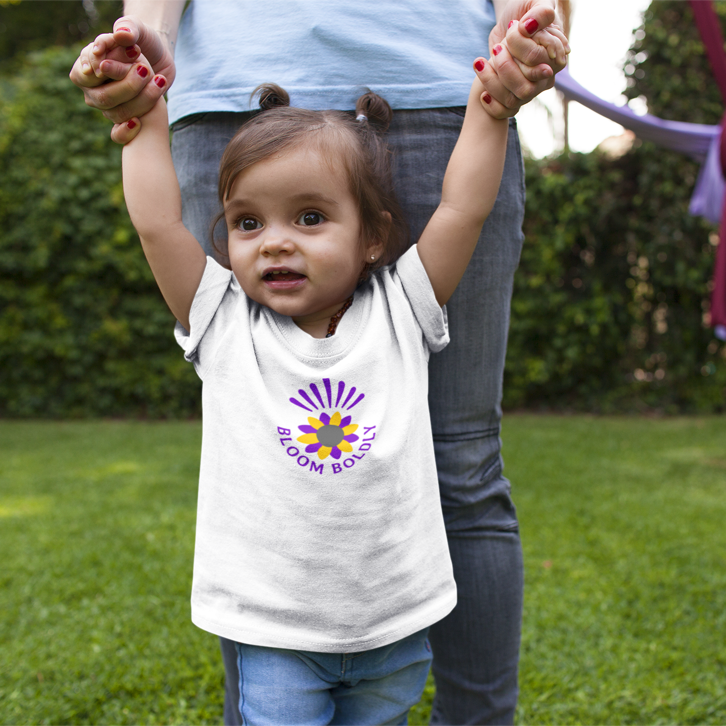 Child wearing a t-shirt with a colorful logo outdoors