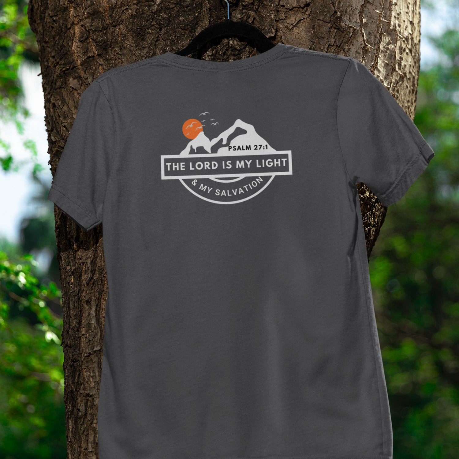 Gray t-shirt with a religious design hanging on a tree
