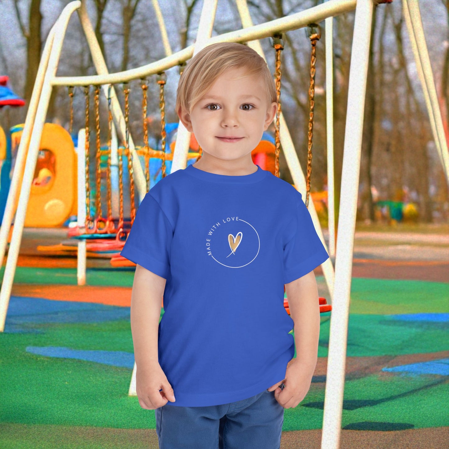 Child wearing a blue t-shirt with a logo on a playground
